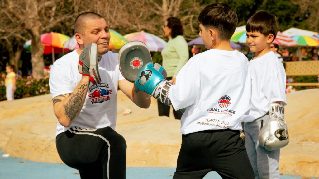 boxing coach mentoring a young boy on discipline and respect