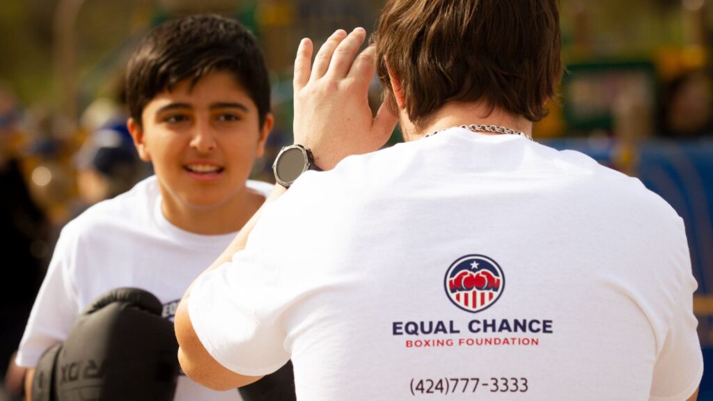 How Boxing Creates Structure for Kids Who Lack Direction boxing coach teaching footwork to teenagers in open air