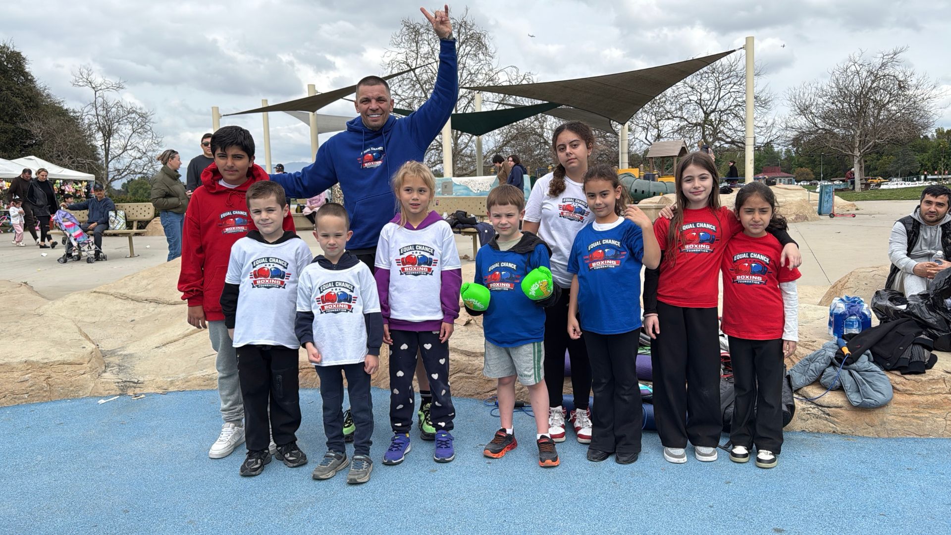About Us children practicing boxing drills on grass during outdoor event