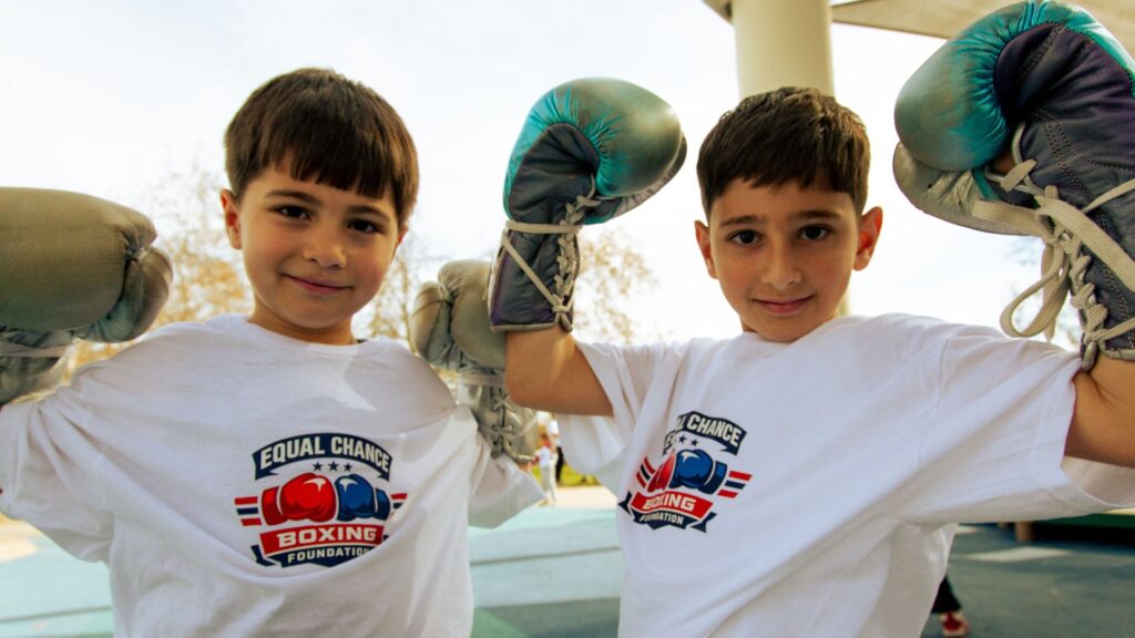group of kids high fiving after a successful boxing drill