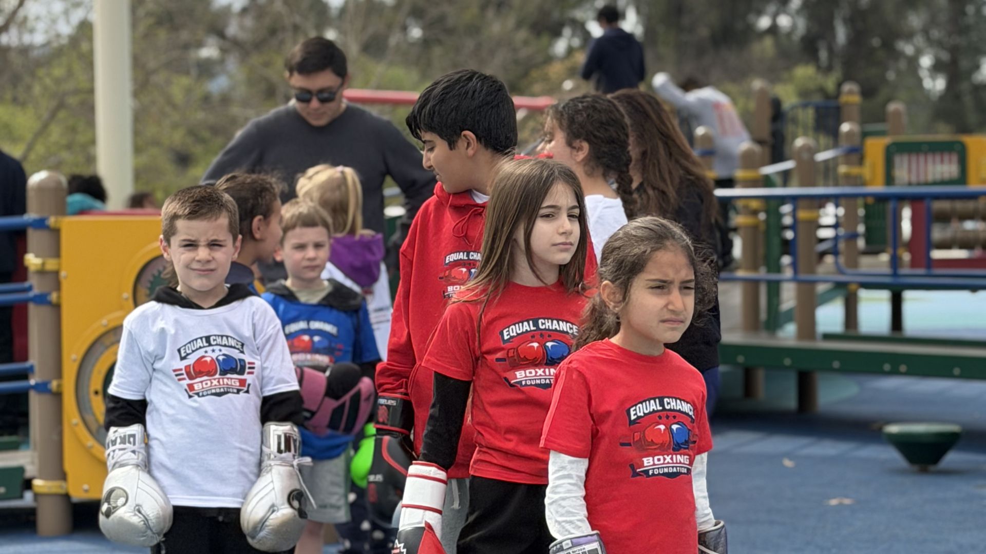 About Us youth boxing training session in a sunny city park