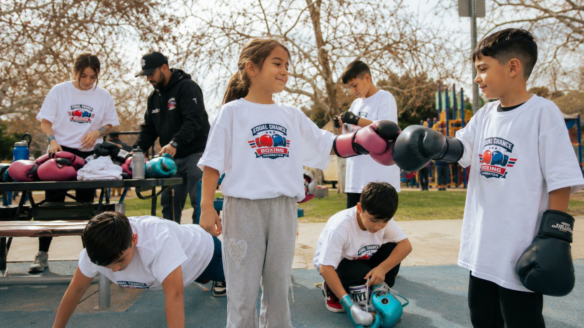 Young boxers preparing together before a community training session at Equal Chance Boxing Foundation